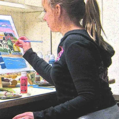 Kori painting at her art table